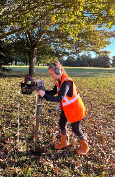Katie O’Hagan, an honours student at the University of Canterbury, taking a soil core at the Manaaki Whenua site in Lincoln.