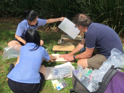 Takapuna Grammar School students pressing plants in the field. Image: Monique Russell