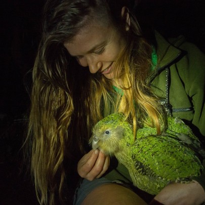 Dr Jo Carpenter with a kākāpō taken on the pest free Anchor Island