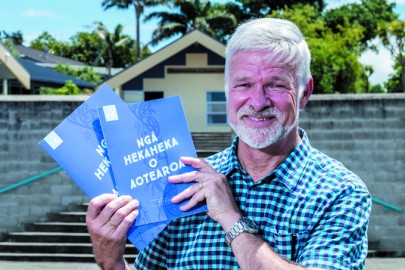 Dr Peter Buchanan holding Ngā Hekaheka o Aotearoa, a booklet he co-wrote on traditional Māori uses of fungi, launched at a kura kaupapa in Auckland.