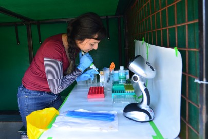 Manpreet Dhami working in the mobile lab in a field near Taupō