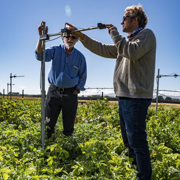 Plant Food Research scientists Peter Jamieson Left and Hamish Brown Right testing the new sensor technology at the Lincoln trial site