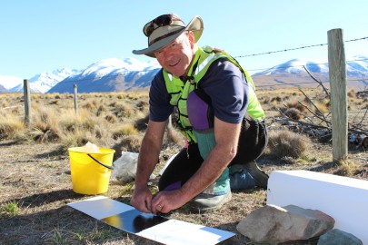 Dr Grant Norbury sets a tracking tunnel to monitor predator abundance