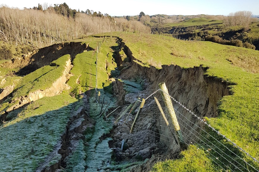 Exposed fence posts left behind after a hill slumps away.