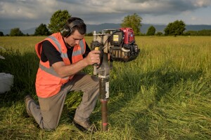 Soil coring on agricultural land.