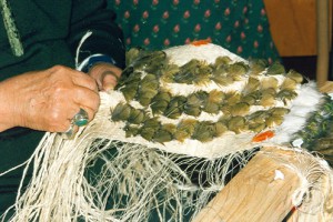 Cath Brown weaves a korowai panel. Image - Sue Scheele 